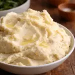 Creamy roasted garlic mashed potatoes served with savory sausage gravy.